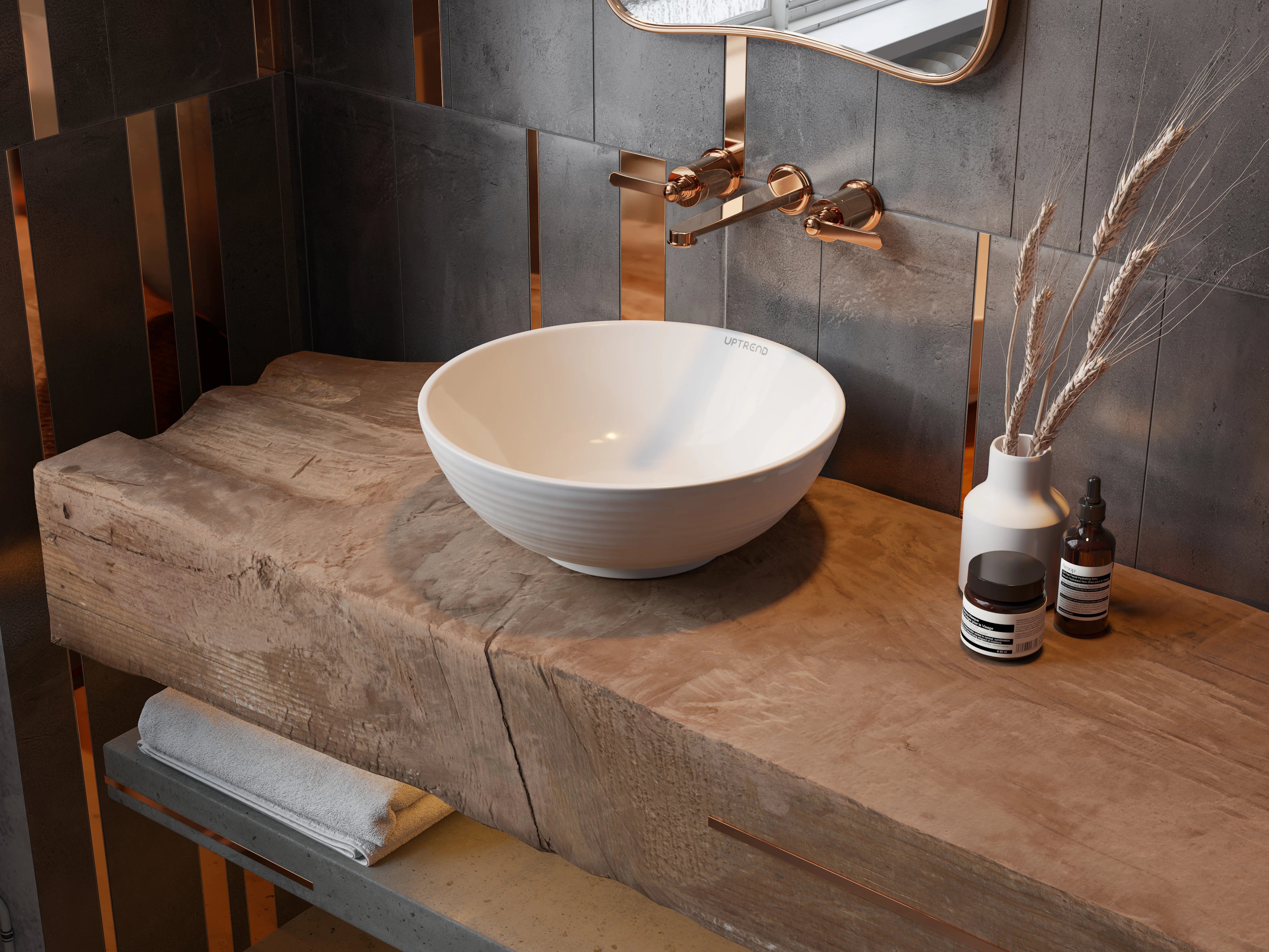ronde keramische waskom wit in badkamer op houten badmeubel met bronze inbouwkraan