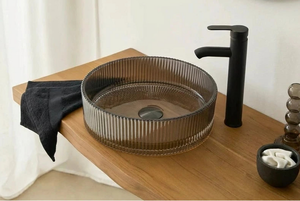 Rookglas waskom met ribbelstructuur en zwarte kraan op houten plank